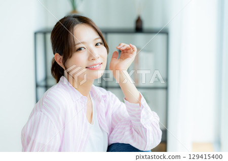 A woman relaxing in the room A woman relaxing in the room 129415400