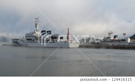 A foggy harbor and a patrol boat 129416315