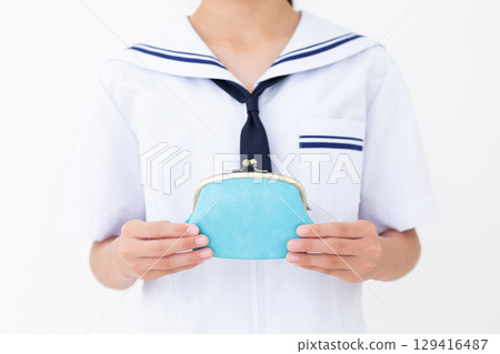 A junior high school girl in a summer school uniform holding a blue clasp wallet 129416487