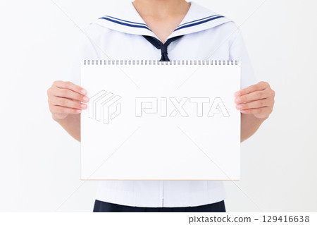 A junior high school girl in a summer school uniform holding a sketchbook A junior high school girl in a summer school uniform holding a sketchbook 129416638