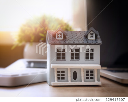Mini house model on desk with sunlight Mini house model on desk with sunlight 129417607