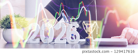 Future year 2026 concept with money, a trophy, and rising financial stock charts, symbolizing investment planning and economic growth. Future year 2026 concept with money, a trophy, and rising financial stock charts, symbolizing investment planning and economic growth. 129417616