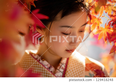 Autumn leaves and a woman wearing a kimono 129418248
