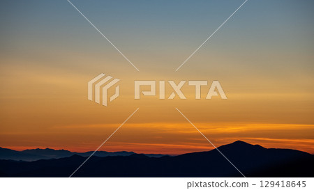 Dawn sky and mountain silhouettes 129418645