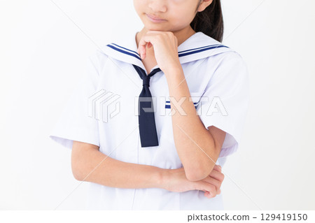 A worried junior high school girl in a school uniform in summer 129419150