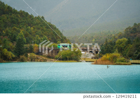 Green Bus Crossing Bridge over Blue Moon Valley, Lijiang Green Bus Crossing Bridge over Blue Moon Valley, Lijiang 129419211