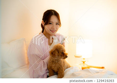 A woman watching a smartphone in bed A woman watching a smartphone in bed 129419263