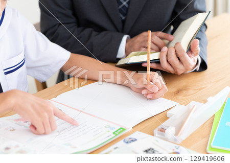A junior high school girl studying and a cram school teacher 129419606