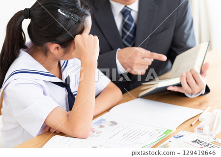 A junior high school girl studying and a cram school teacher 129419646