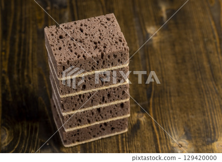 sponge with of holes for good foaming of detergents and is used for cleaning, brown sponge for washing dirty dishes 129420000