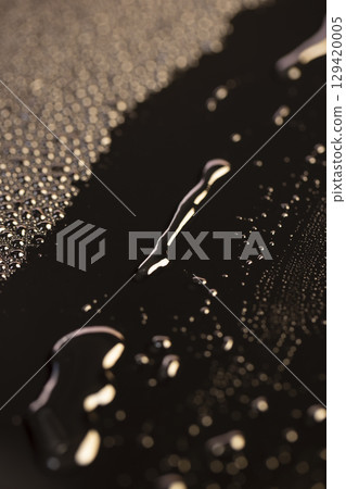 black glass surface in water drops, wet mirrored black glass in a large number of water droplets black glass surface in water drops, wet mirrored black glass in a large number of water droplets 129420005