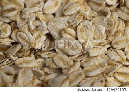 a cable twisted in the shape of a spring , an old black cable in a rubber braid for connecting different devices 129420165