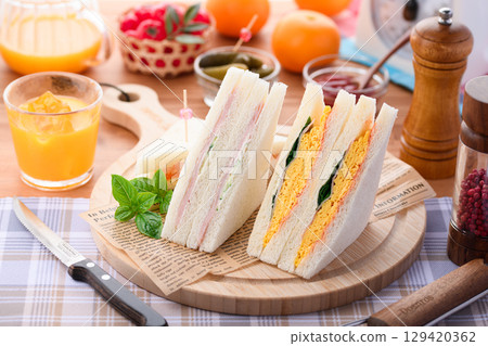 混合三明治和柳橙汁是完美的早餐或午餐，在時尚的咖啡館風格環境中呈現。 129420362