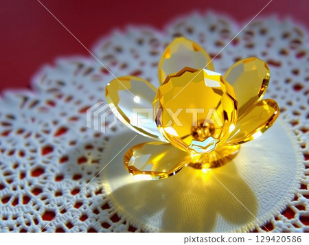 Luminous Crystal Flower Resting on Delicate Lace 129420586