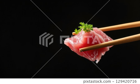 Fresh tuna sliced on wooden chopsticks 129420716