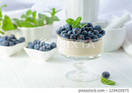 Mascarpone cream with fresh blueberries in a clear bowl. Mascarpone cream with fresh blueberries in a clear bowl. 129420975