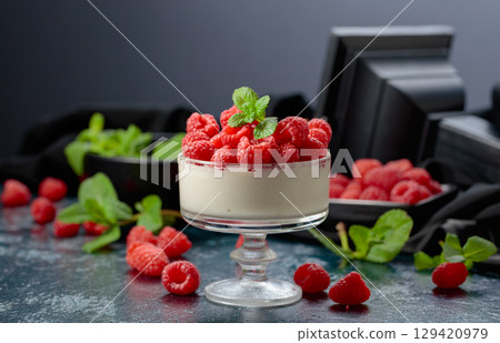Mascarpone cream with fresh raspberries in a clear bowl. Mascarpone cream with fresh raspberries in a clear bowl. 129420979