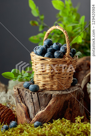 Small wicker basket filled with ripe blueberries. Small wicker basket filled with ripe blueberries. 129420984