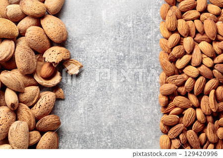 Almonds on a stone background. 129420996