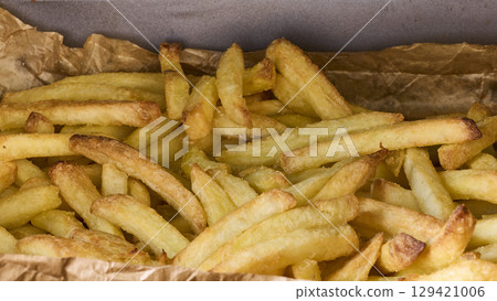 Golden Crispy French Fries on Baking Paper Golden Crispy French Fries on Baking Paper 129421006