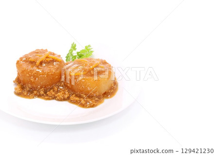 Daikon radish with minced meat sauce on a bright background Daikon radish with minced meat sauce on a bright background 129421230