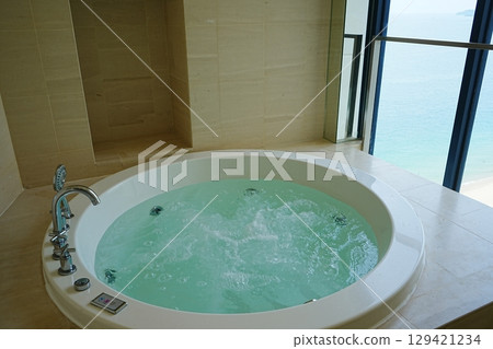 Jacuzzi A bathtub filled with hot water Jacuzzi A bathtub filled with hot water 129421234