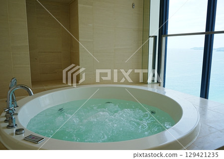 Jacuzzi A bathtub filled with hot water Jacuzzi A bathtub filled with hot water 129421235