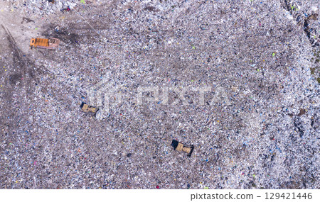 Bird's eye view of a garbage dump where machinery equals mountains of household waste, Ukraine. Ecological problem Bird's eye view of a garbage dump where machinery equals mountains of household waste, Ukraine. Ecological problem 129421446