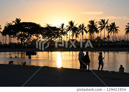 Children playing on the beach at sunset Children playing on the beach at sunset 129421954