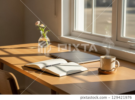 Minimal Home Office Desk with Notebook, Coffee, and Sunlight Minimal Home Office Desk with Notebook, Coffee, and Sunlight 129421976