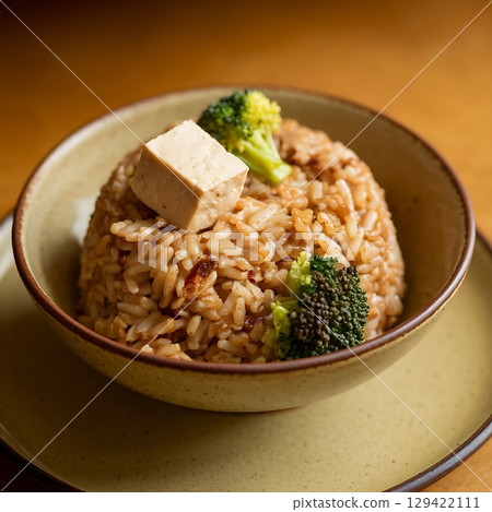 Vegetarian Rice Bowl with Fresh Broccoli and Tofu on Ceramic Plate 129422111