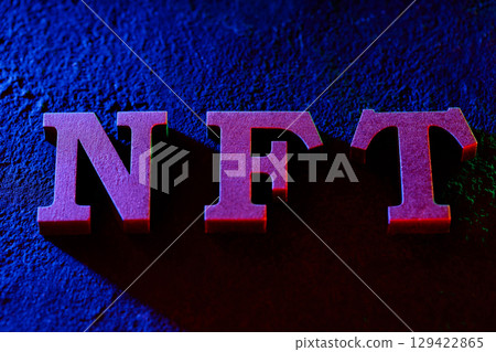 NFT Letters Glowing with Neon Light on Dark Grunge Background 129422865