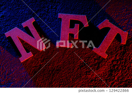 NFT Letters Glowing with Neon Light on Dark Grunge Background 129422866