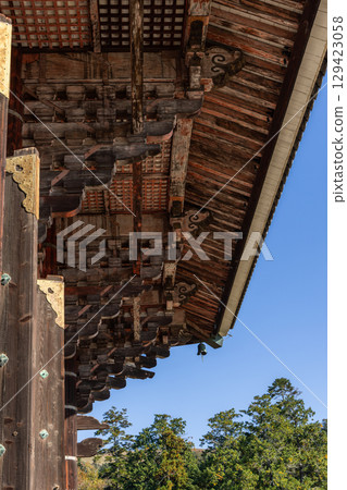 Detailed view of traditional wooden roof structure with intricate carpentry Todai-ji Temple in Nara Detailed view of traditional wooden roof structure with intricate carpentry Todai-ji Temple in Nara 129423058