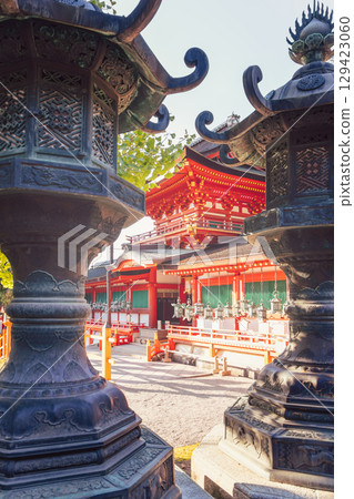 Bronze lanterns frame the view of vibrant red Kasugataisha Shrine in Nara Japan Bronze lanterns frame the view of vibrant red Kasugataisha Shrine in Nara Japan 129423060