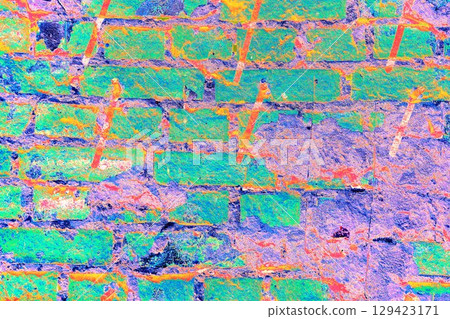 Peeling paint on a brick wall. Old brick wall with cracked peeling paint and metal pins. 129423171