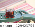 A cup of herbal tea in the country, a glass of tea on the country swing. 129423754