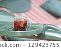 A cup of herbal tea in the country, a glass of tea on the country swing. 129423755
