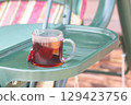 A cup of herbal tea in the country, a glass of tea on the country swing. 129423756