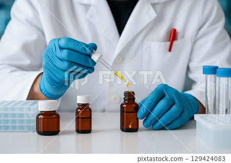 AI generated a scientist in lab coat and blue gloves dispensing yellow liquid into amber vial among test tubes and sample containers reflecting sterile environment and careful scientific procedure 129424083