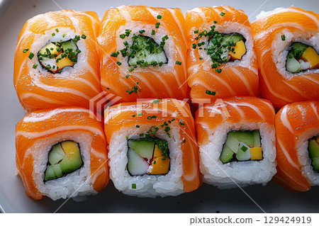Plate of sushi with a variety of ingredients including cucumber, avocado 129424919