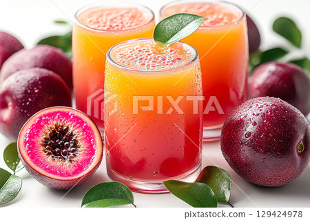 Three glasses of fruit juice with a lime wedge on top 129424978