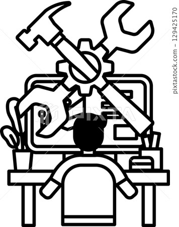 A man is sitting at a desk with a computer and a toolbox 129425170