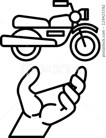 A hand is holding a motorcycle 129425592