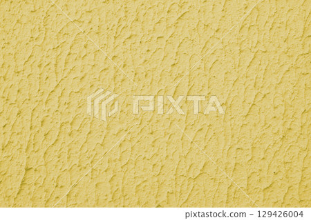 Rough yellow colored concrete or plaster wall texture background Rough yellow colored concrete or plaster wall texture background 129426004