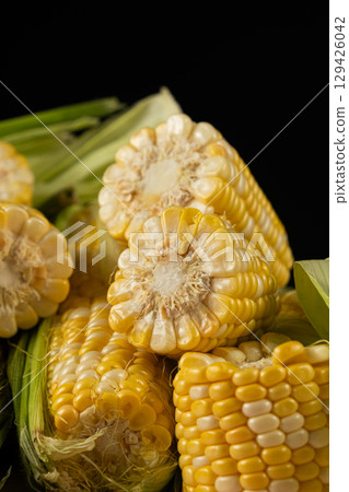 Close-up view of fresh raw corn cobs ready for cooking. 129426042