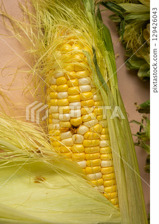 Fresh ripe corn cob with rotten kernels Fresh ripe corn cob with rotten kernels 129426043