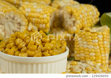 Bowl Of Preserved Corn Kernels With Fresh Corn Cobs Around. Bowl Of Preserved Corn Kernels With Fresh Corn Cobs Around. 129426050