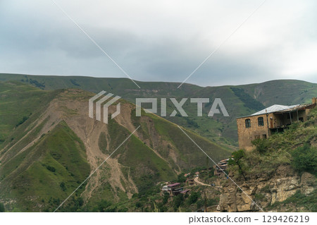 A mountain range with a house on top of it A mountain range with a house on top of it 129426219