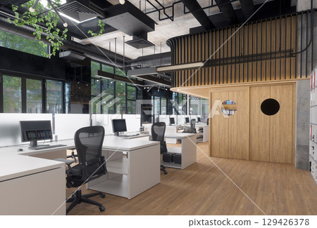 Modern office space with empty desks and computers. Contemporary workspace for business and productivity. Modern office space with empty desks and computers. Contemporary workspace for business and productivity. 129426378